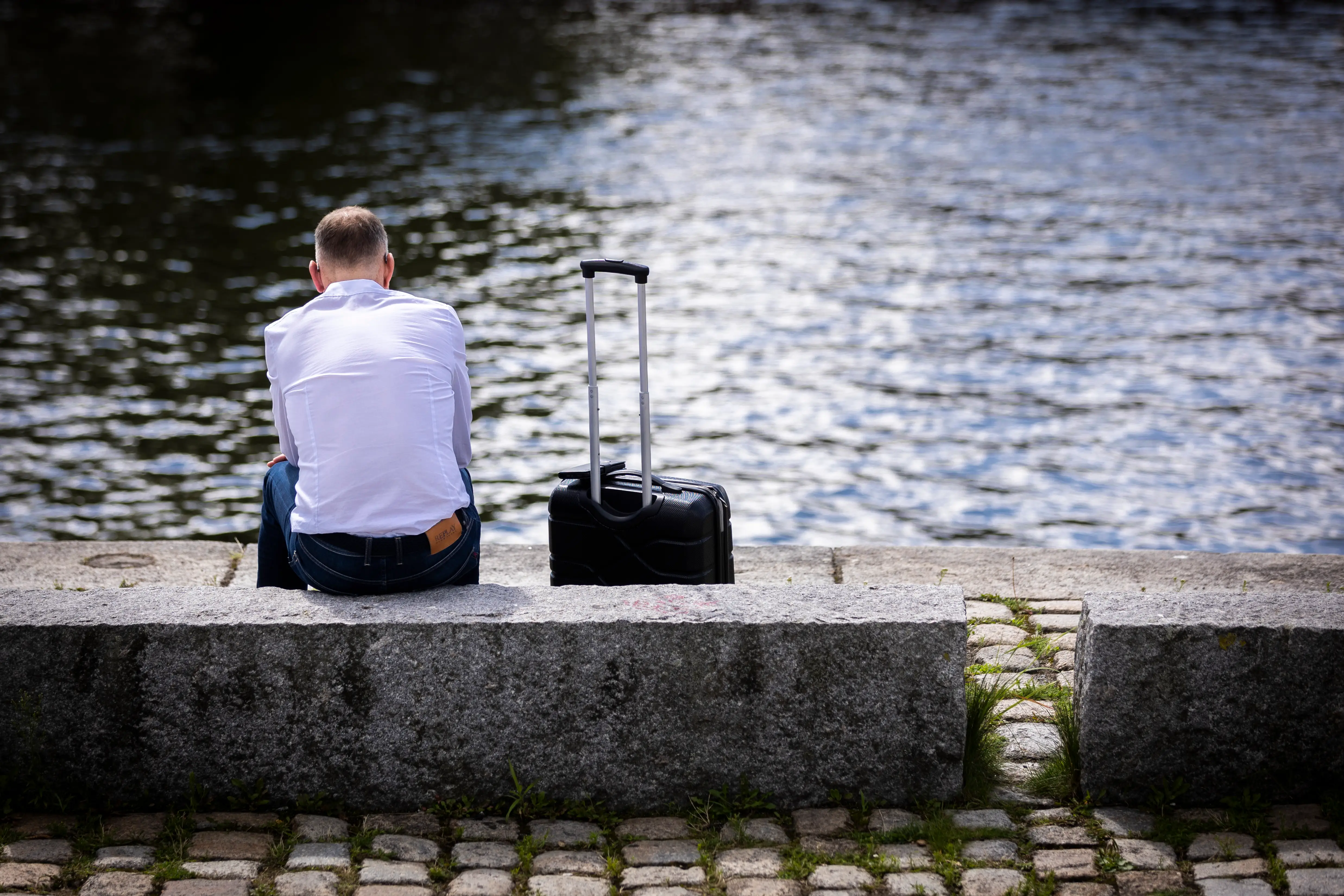Man sitting next to luggage