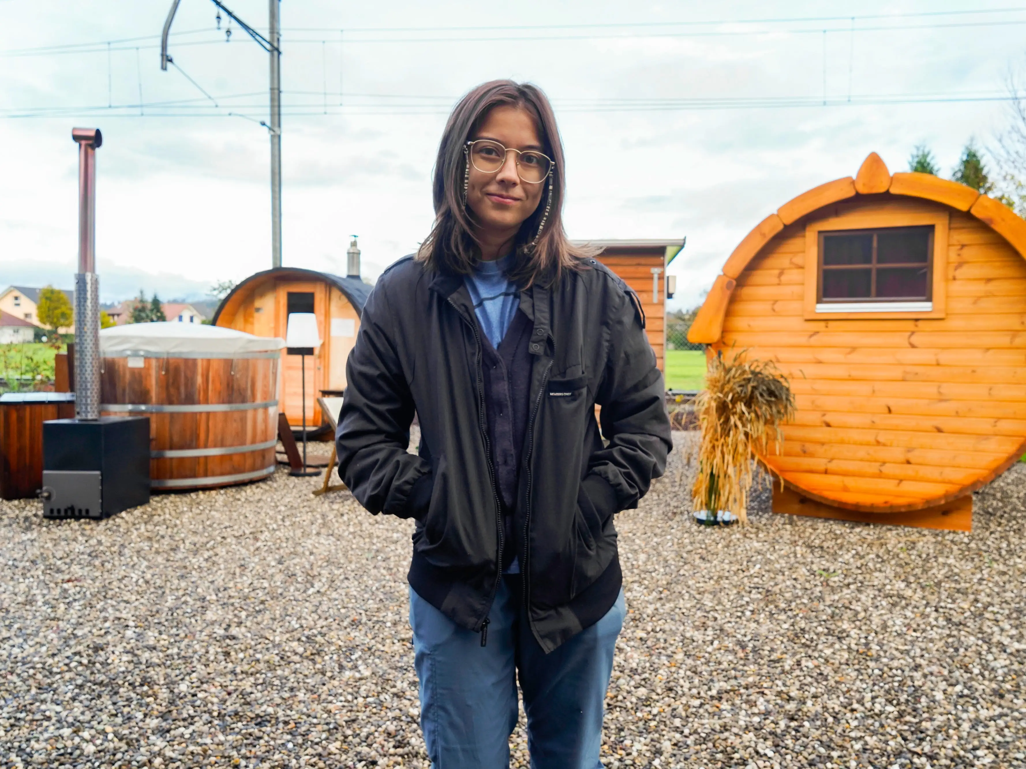The author standing in front of wine barrels in a gravel yard in Switzerland