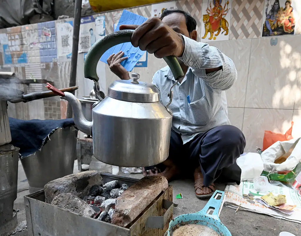 A tea seller uses a coal stove in New Delhi.