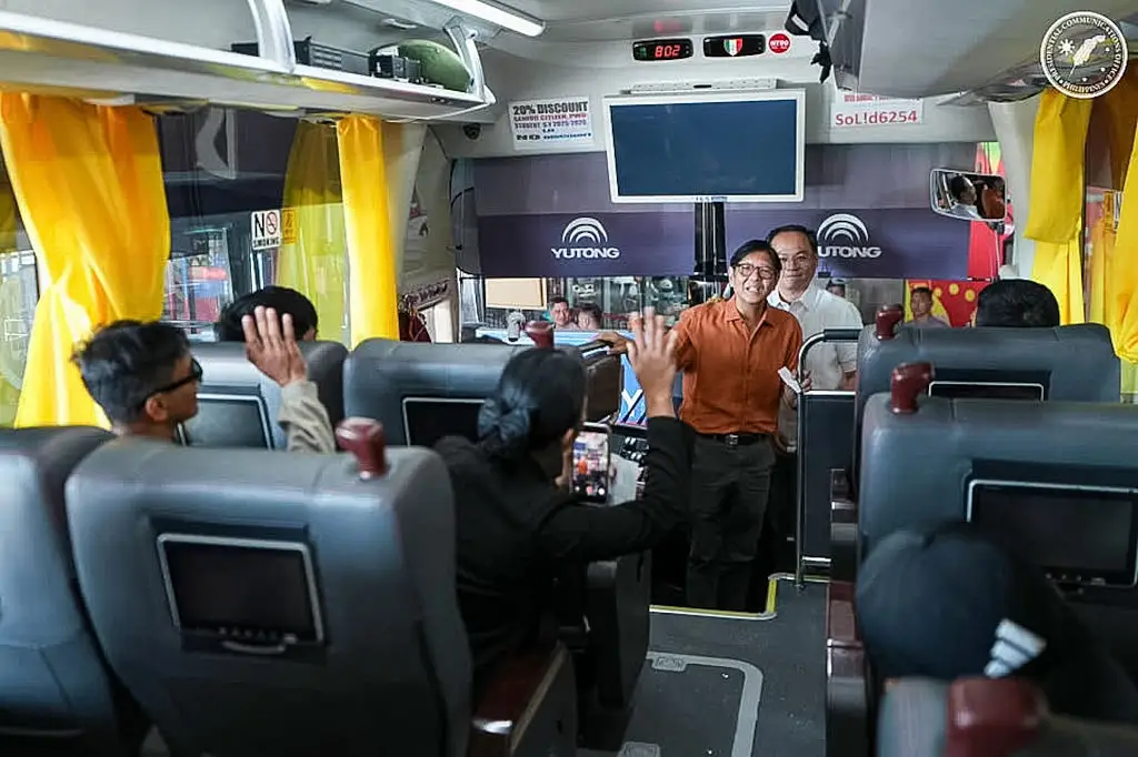 Philippine President Ferdinand Bongbong Marcos Jr. greets passengers on a bus.