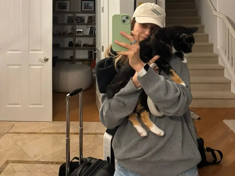 Woman smiling taking selfie while holding