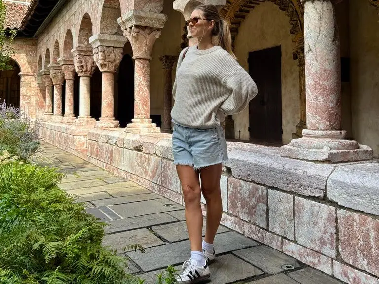 Woman standing in front of columns and arches
