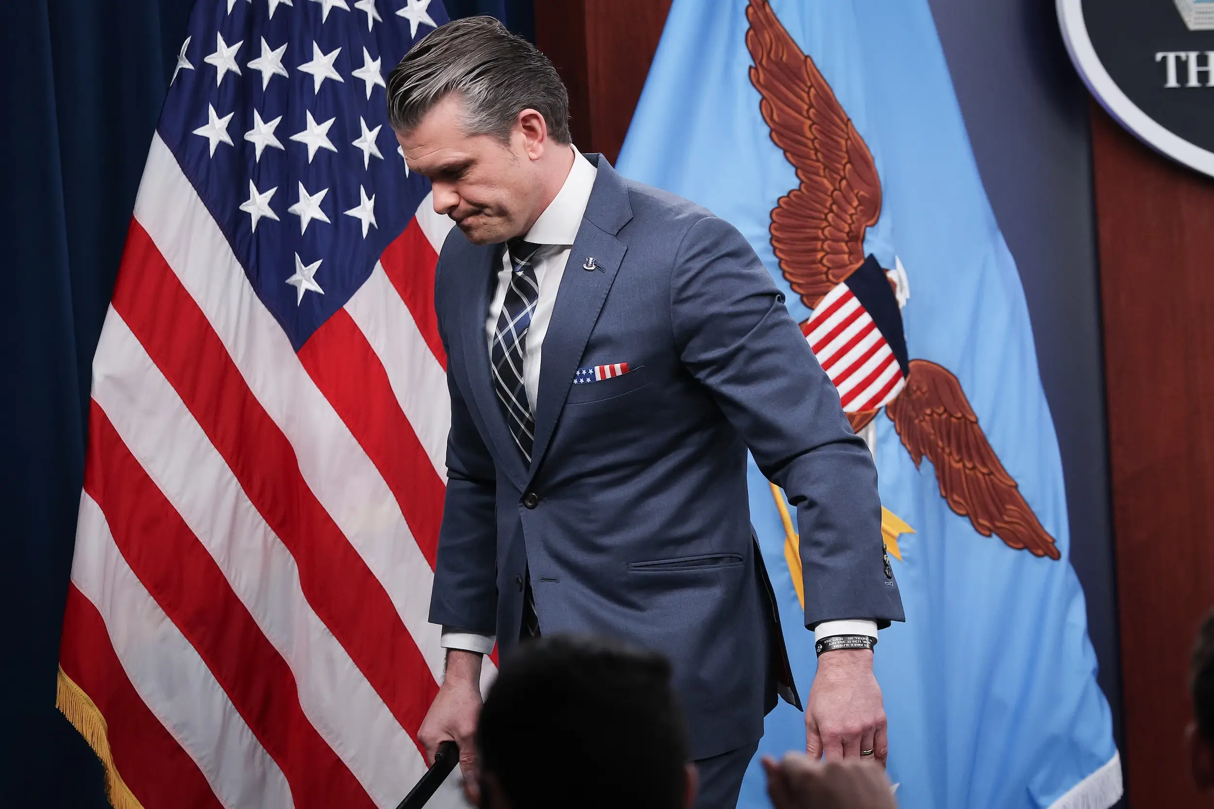 Pete Hegseth leaves a news conference at the Pentagon