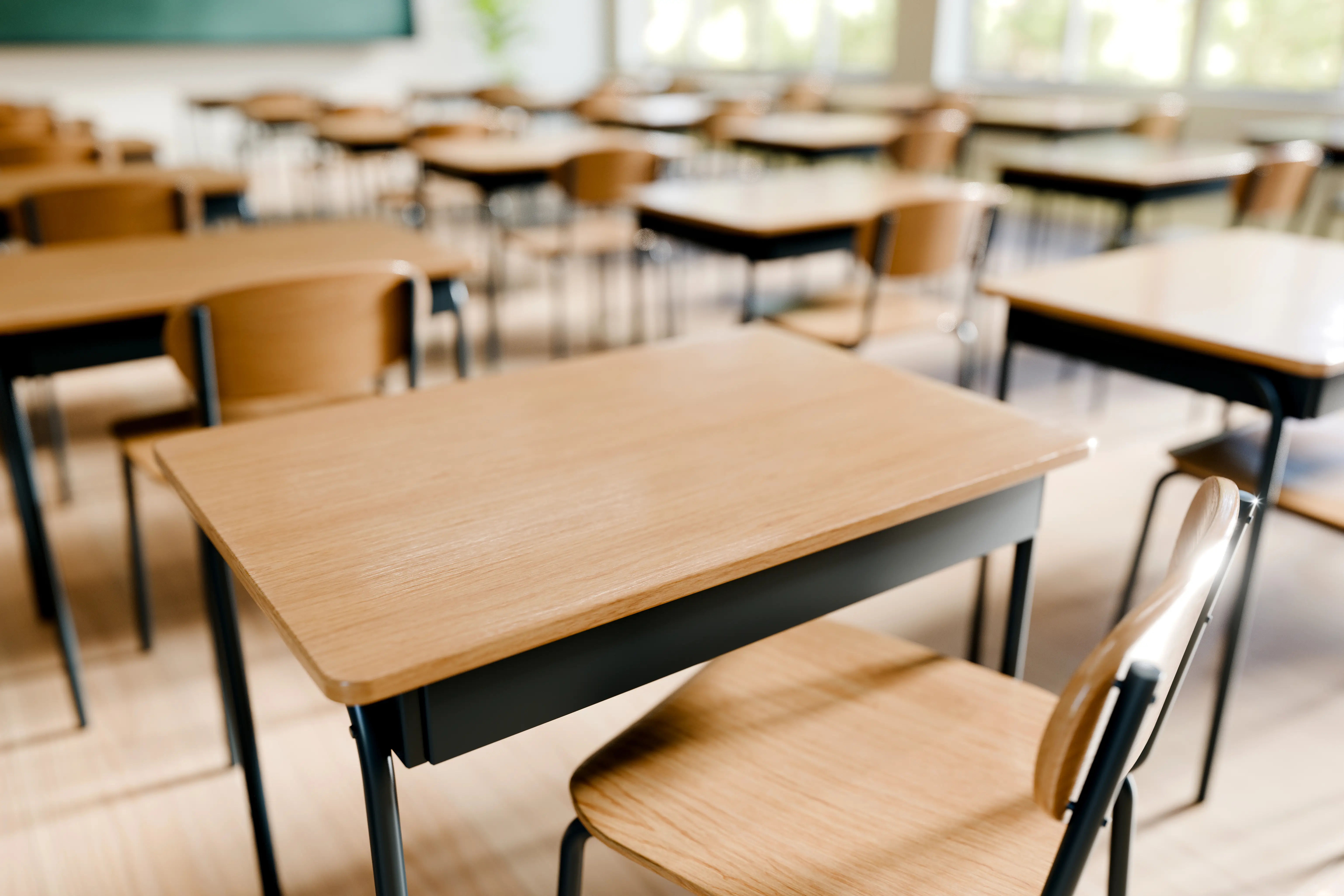 An empty classroom full of desks.