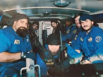 Frank D'alesio on left in ATF blue uniform with group of other ATF agents.