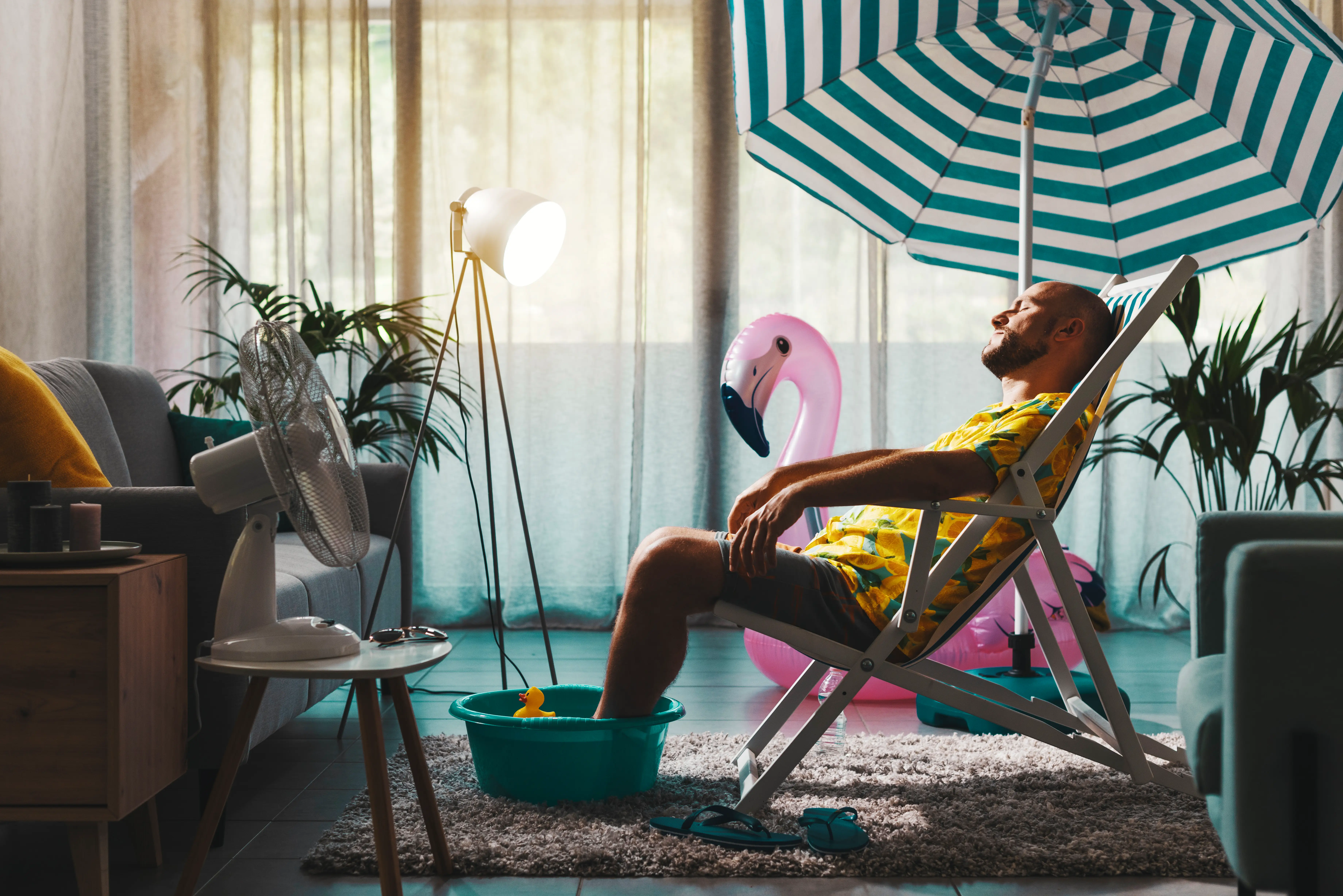 A man relaxes in a beach chair in his living room.