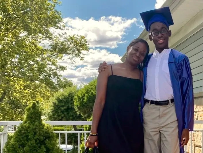 lisa white and her son in a graduation gown