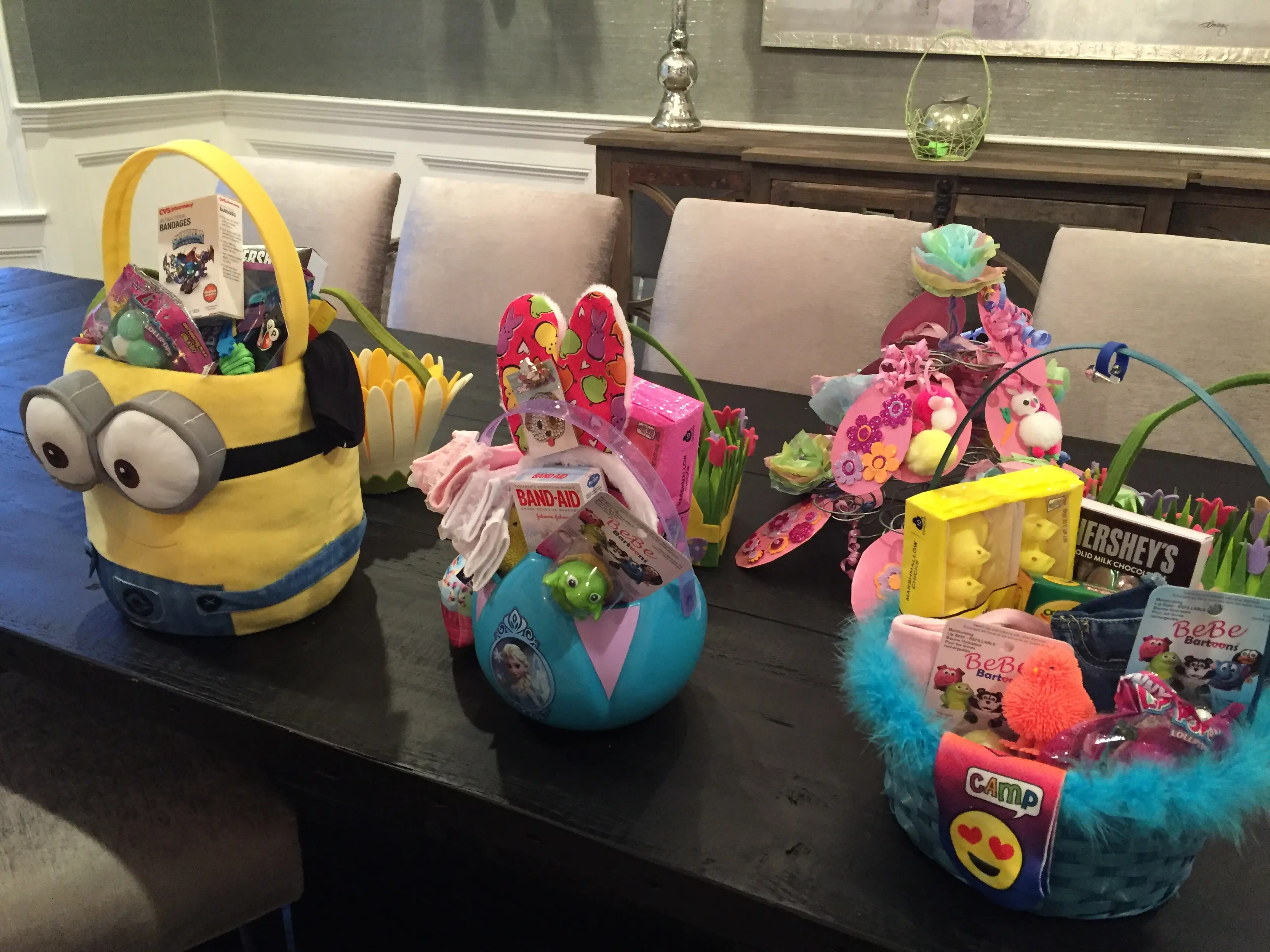 Easter baskets piled high sit atop a dining room table.