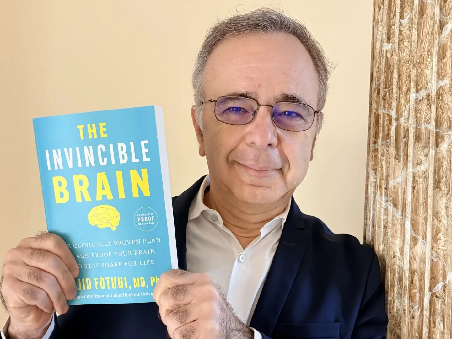 Majid Fotuhi holding book