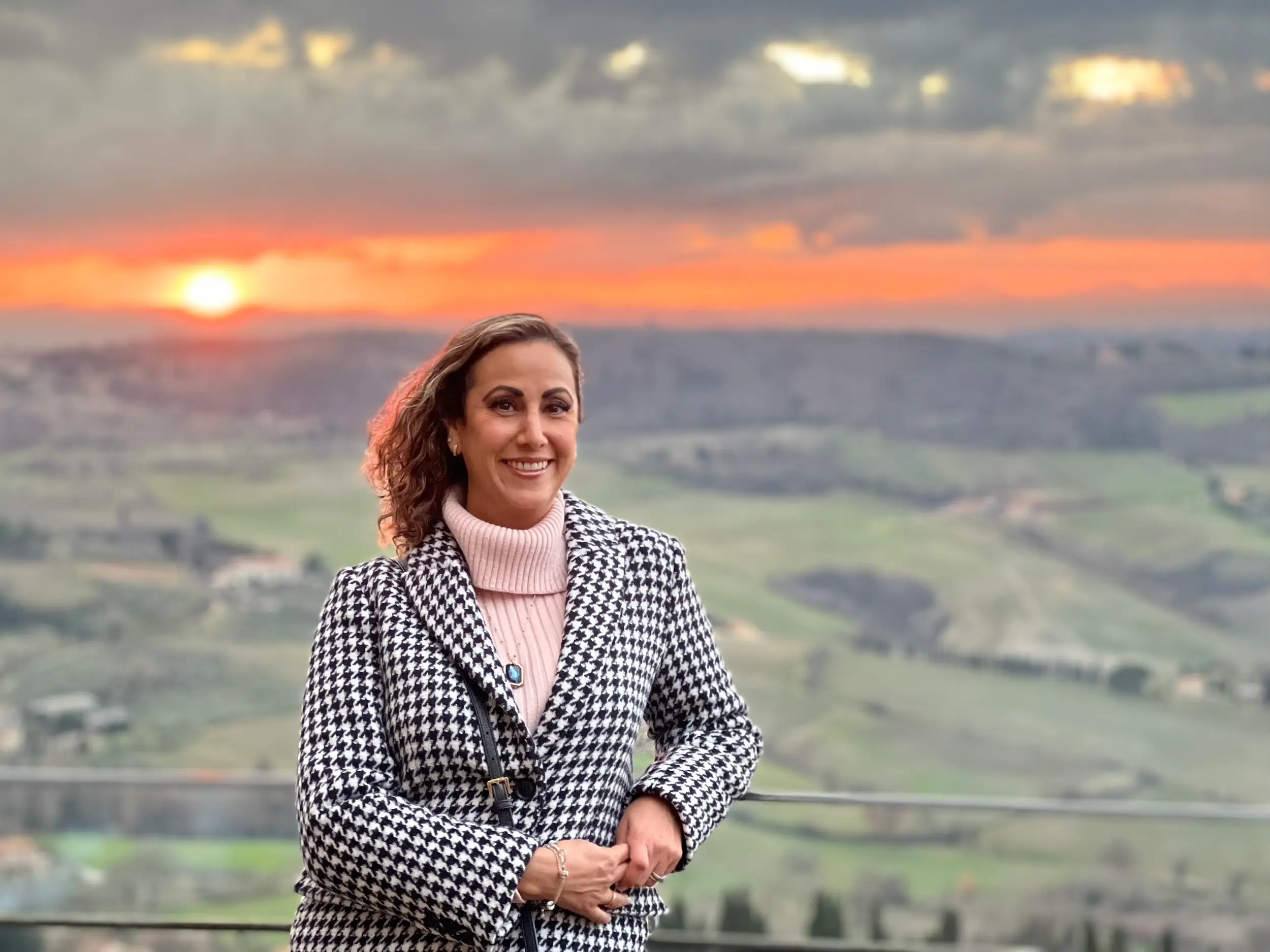 A woman posing during a sunset in Italy.