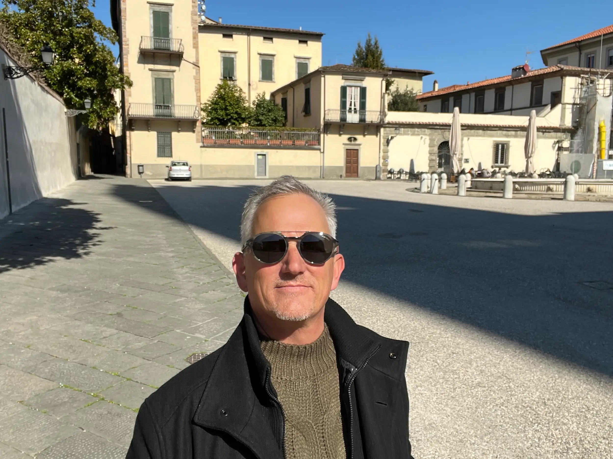 A man standing outside of a building in Italy.