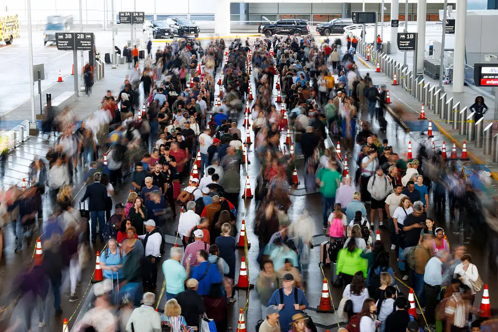 Crowds lined up in a parking lot at IAH airport