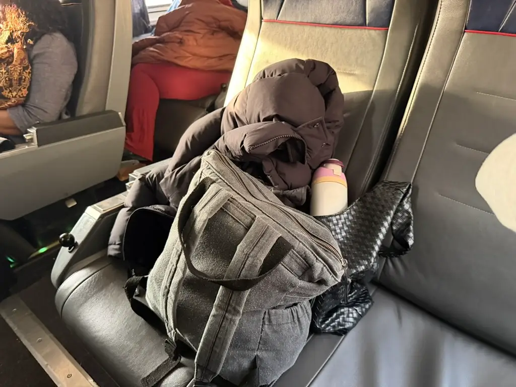 Author luggage inside Amtrak coach seat