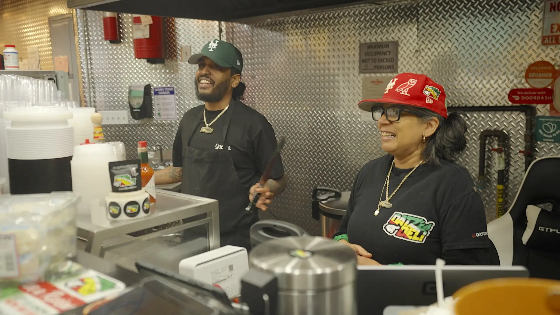 Joshua Dat standing next to his mom in Datz Deli.