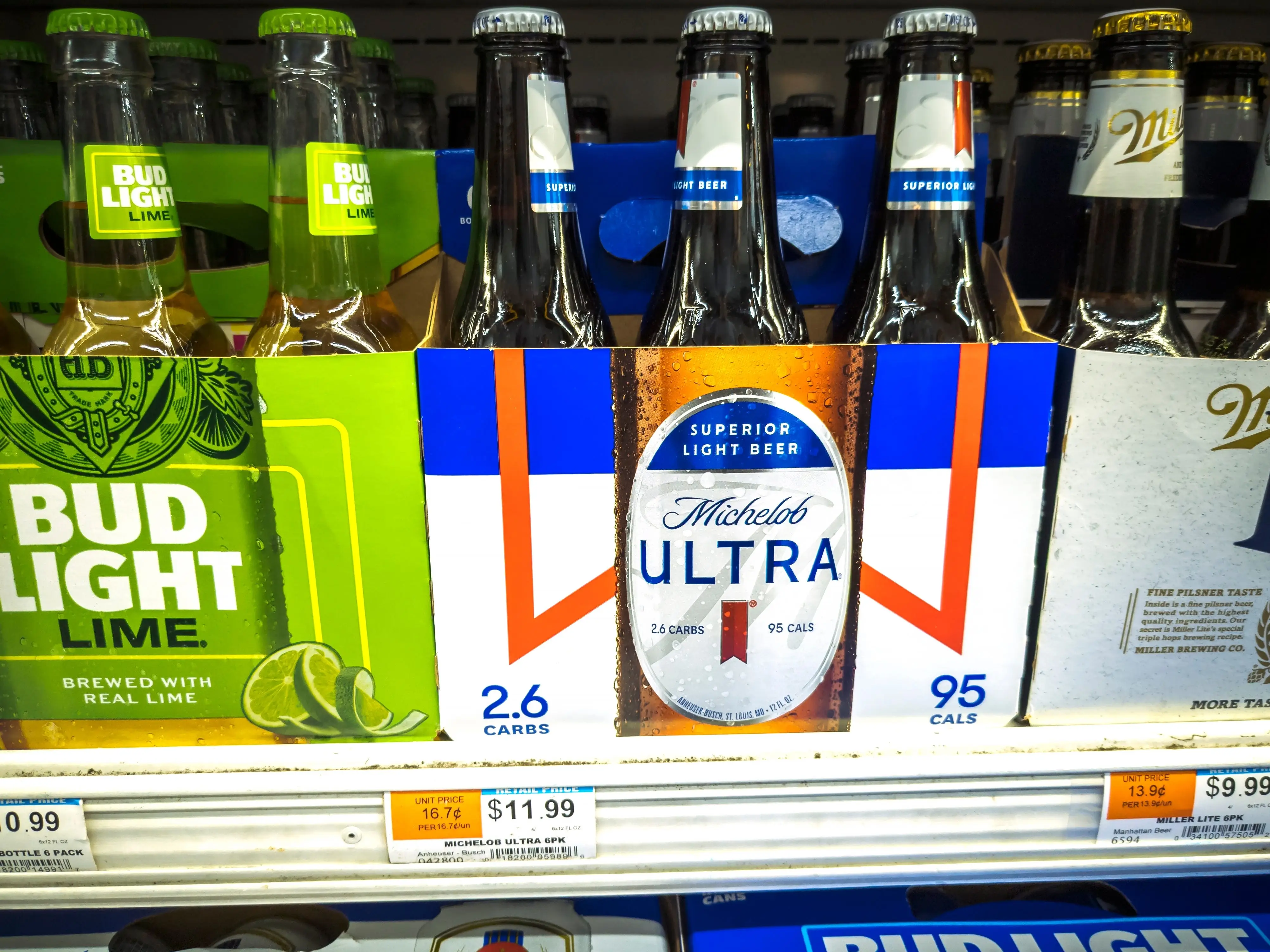 Bud Light, Michelob Ultra, and Miller Lite on a shelf.