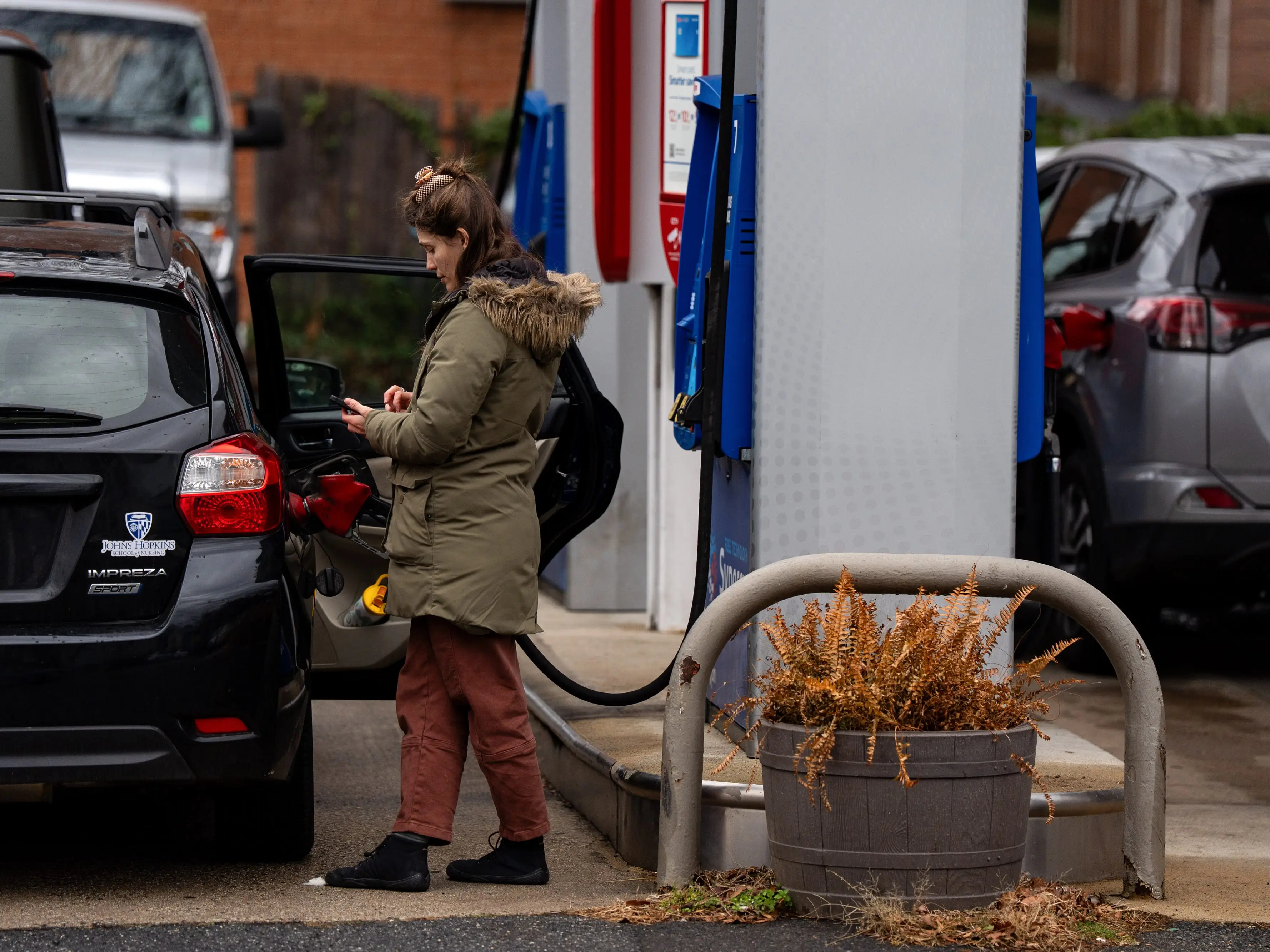 A driver refuels a vehicle at an Exxon gas station in Arlington, Virginia, US, on Tuesday, Dec. 23, 2025.