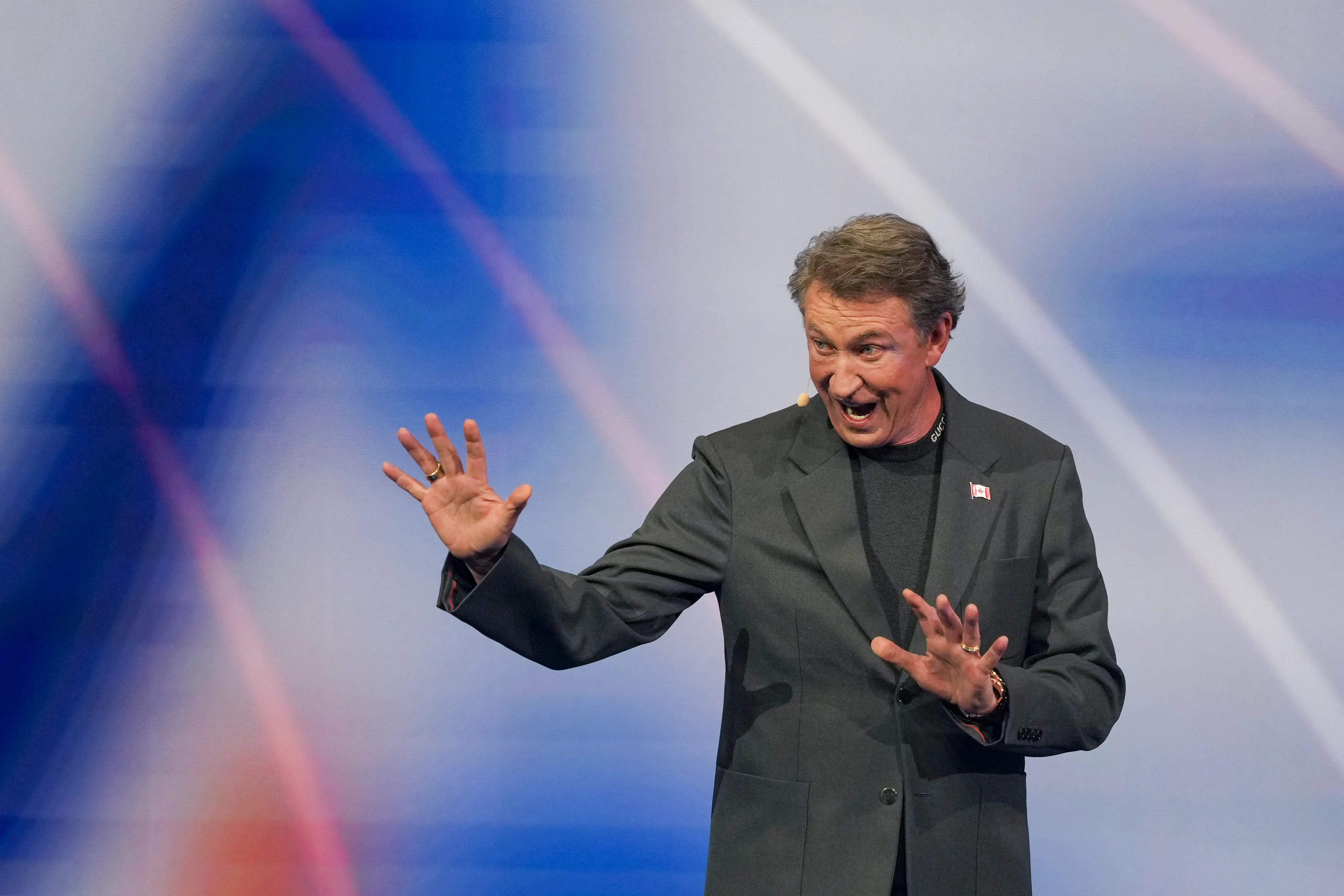 Wayne Gretzky stands on stage at the World Cup draw