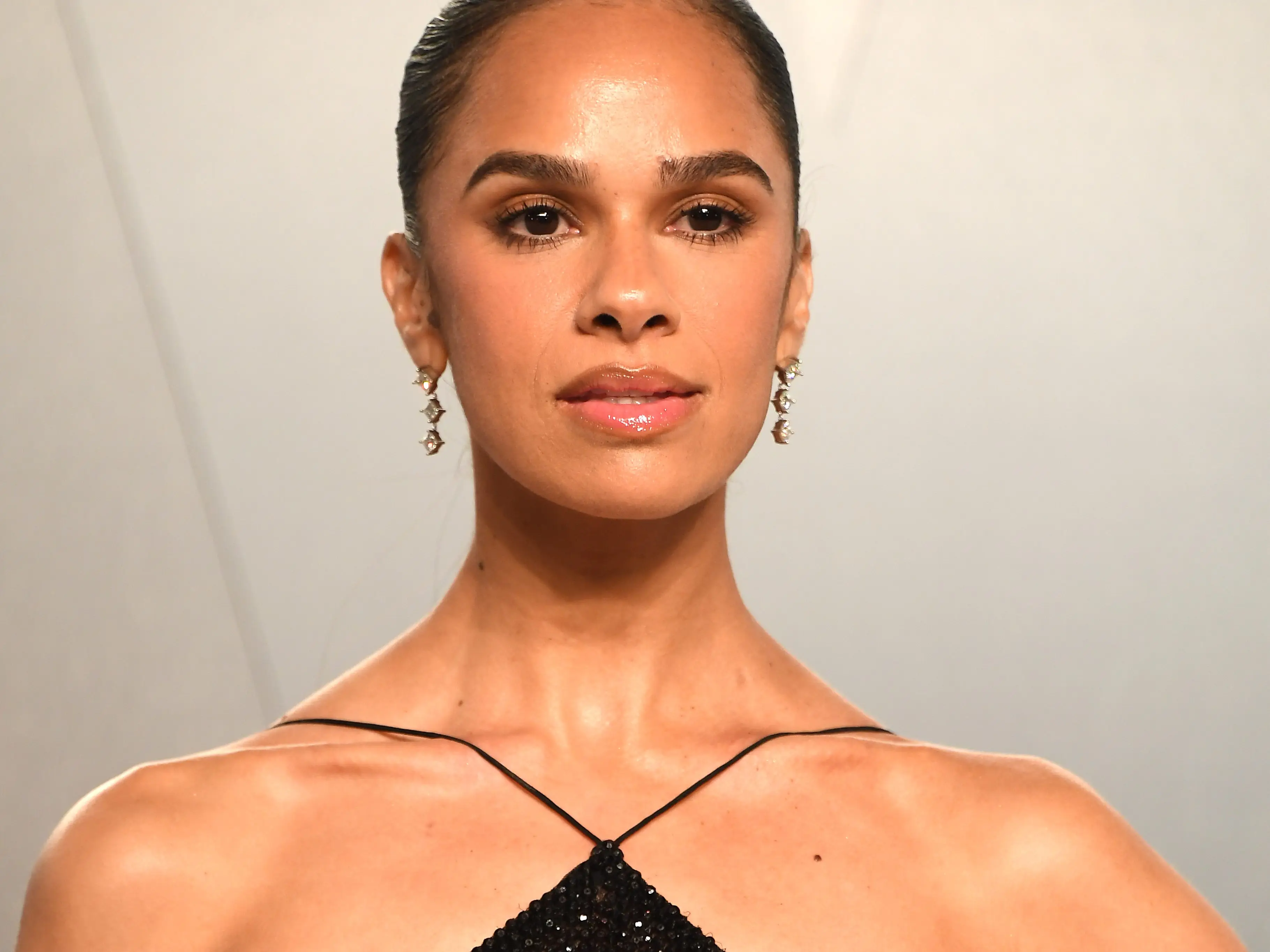 Misty Copeland poses before an event in a black dress