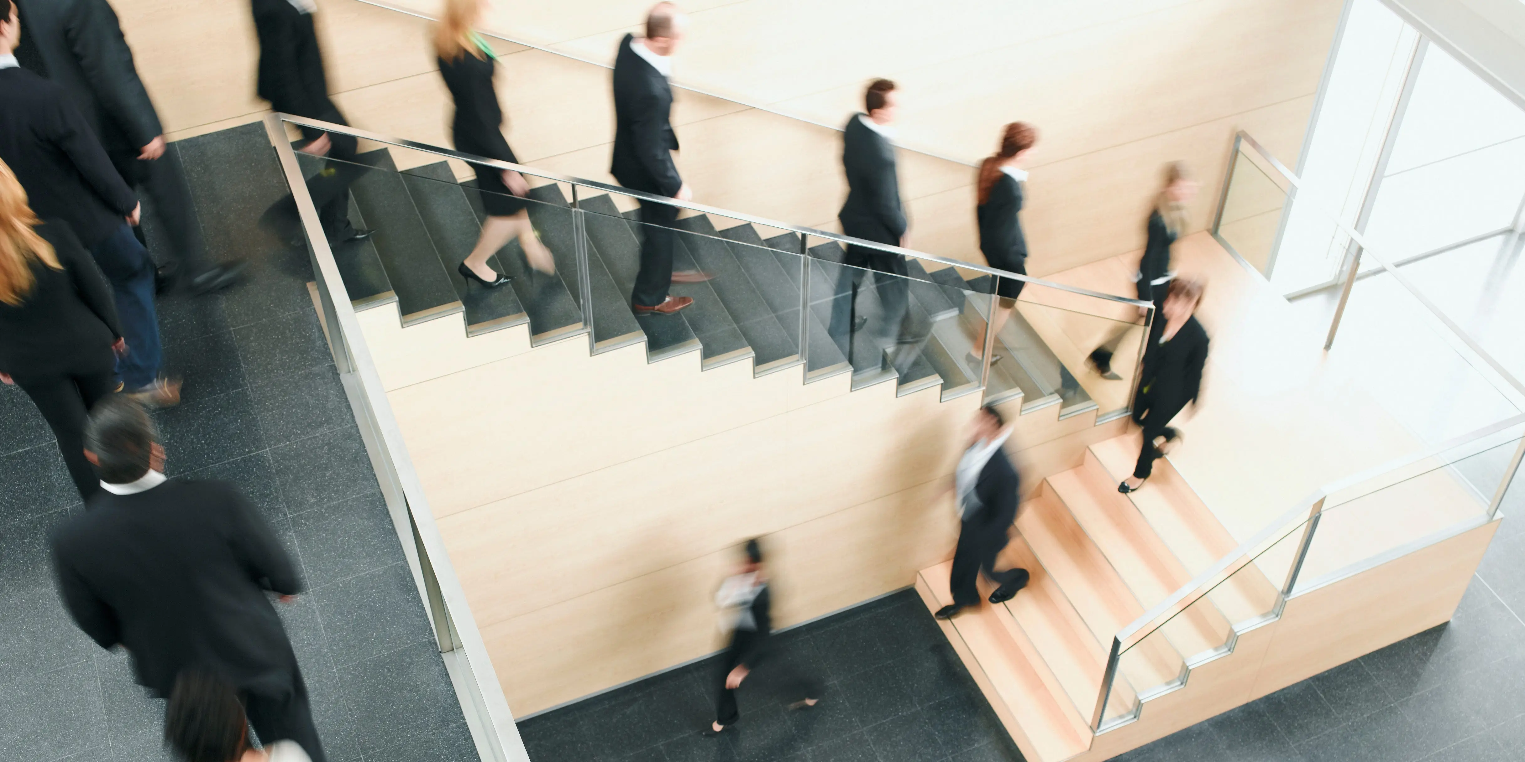 Businesspeople walking down office staircase