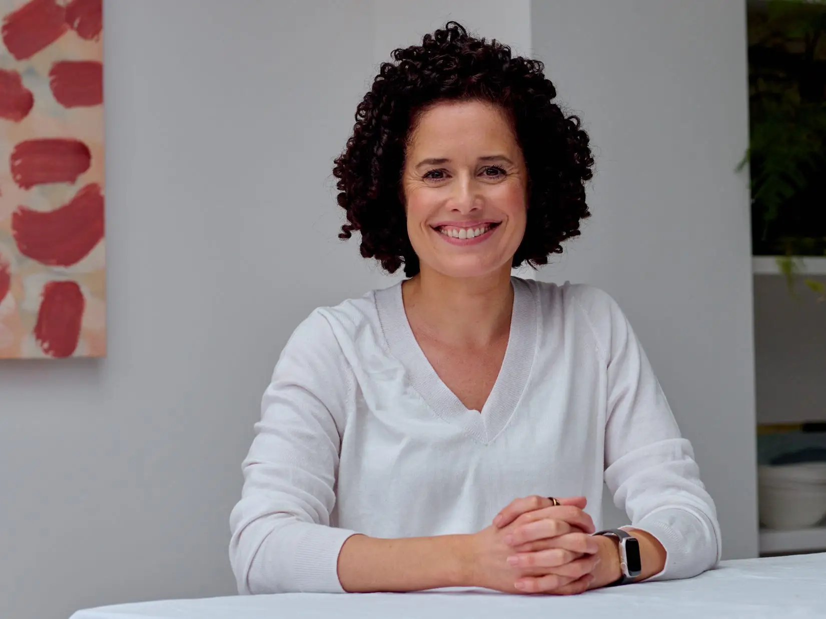 Sarah Berry sits at a table.