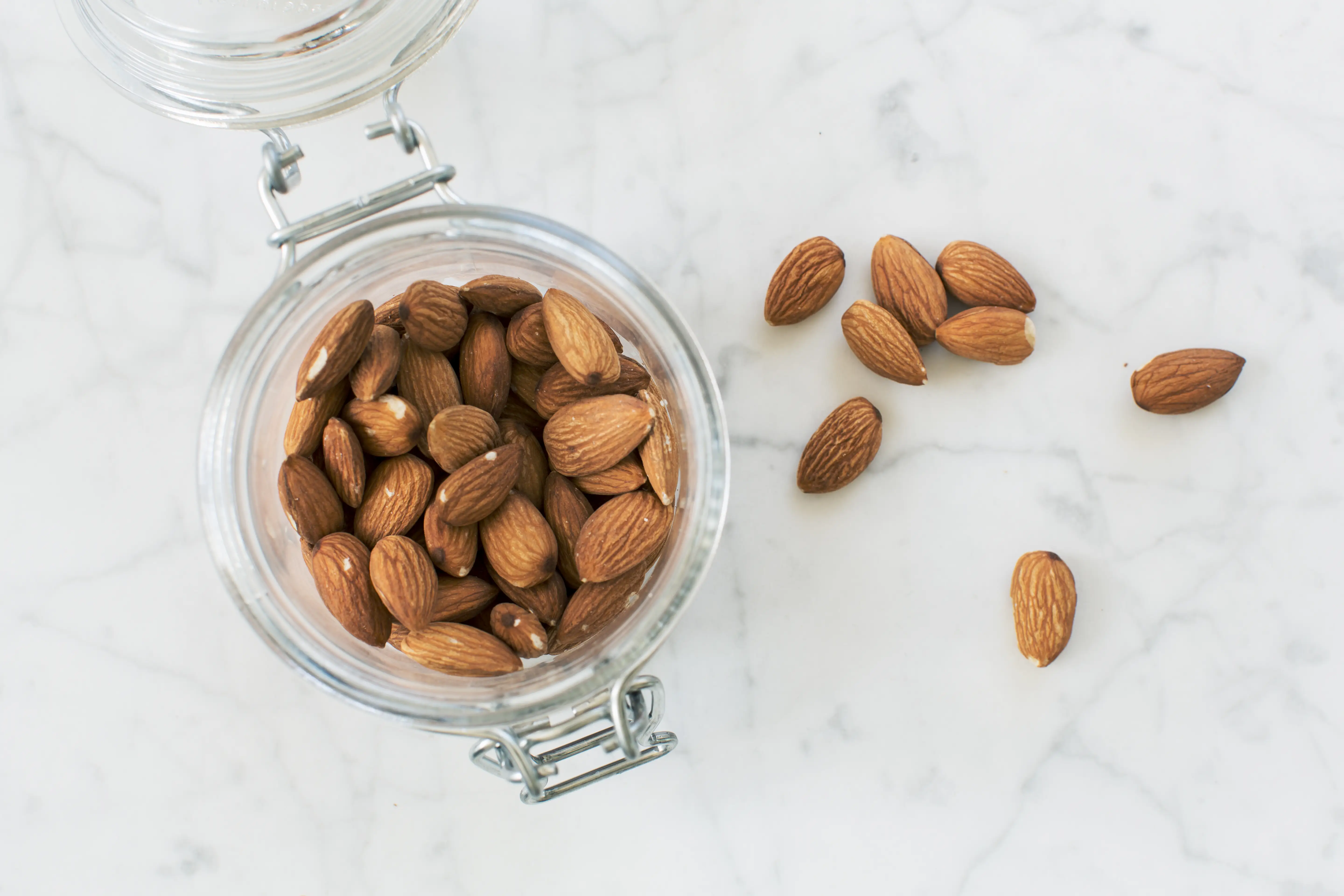 A birdseye view of a jar of almonds.