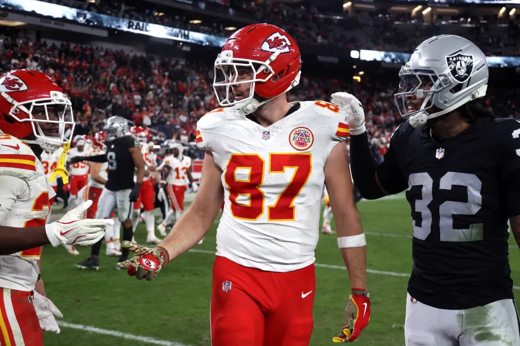 Travis Kelce and Lonnie Johnson Jr. of the Kansas City Chiefs and Las Vegas Raiders, respectively, after a game at Allegiant Stadium.