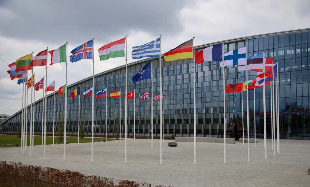 National flags of NATO member countries flying outside the organization's headquarters in Brussels, Belgium.