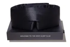 A thick black sleep mask and its case.