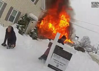 Dramatic footage captures cops desperately hunting for hydrants under snow as blaze critically hurts mom, tot