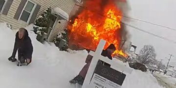 Dramatic footage captures cops desperately hunting for hydrants under snow as blaze critically hurts mom, tot