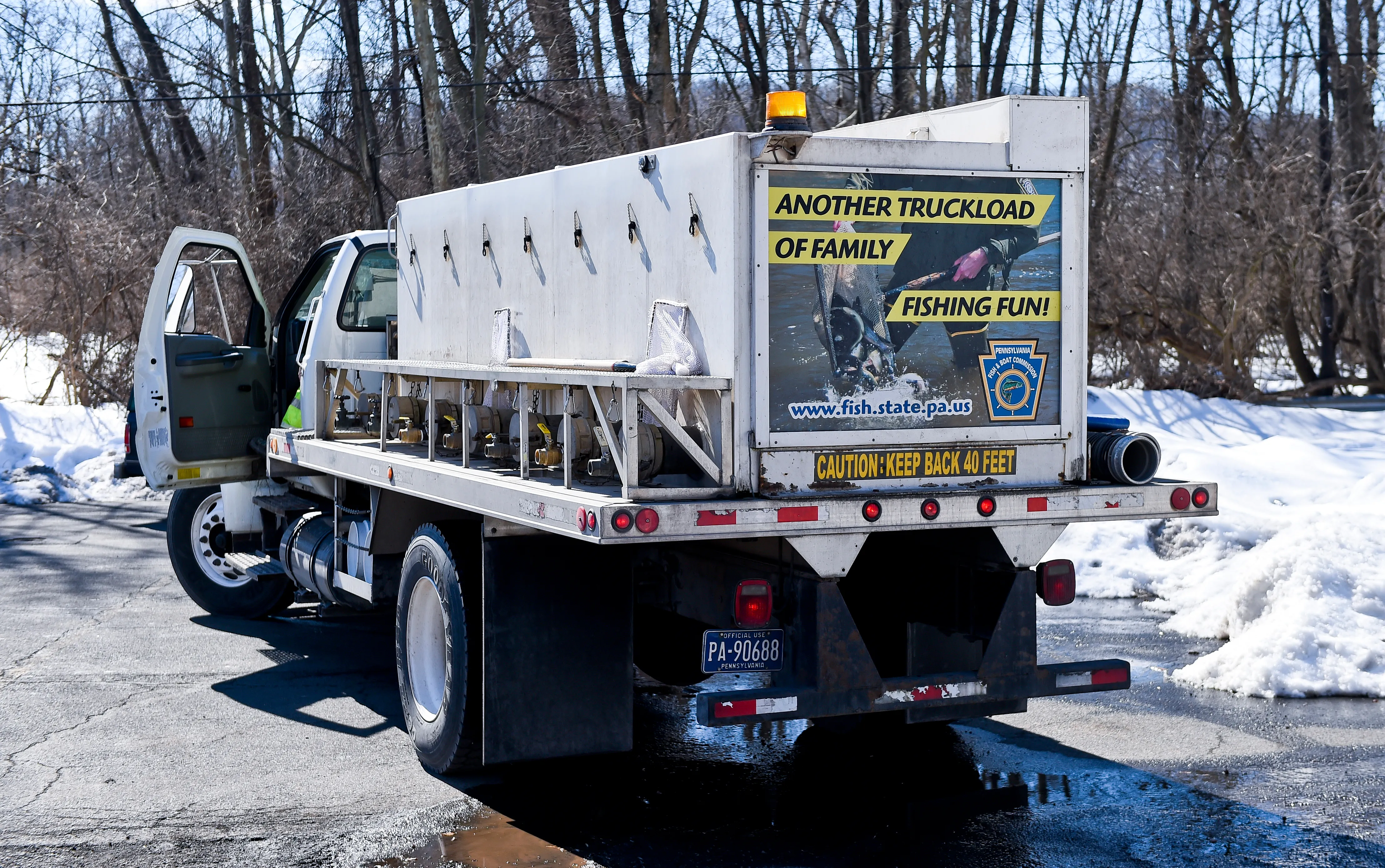 A truck with a sign on the back that reads another truckload of family fishing fun A truck with a sign on the back that reads another truckload of family fishing fun