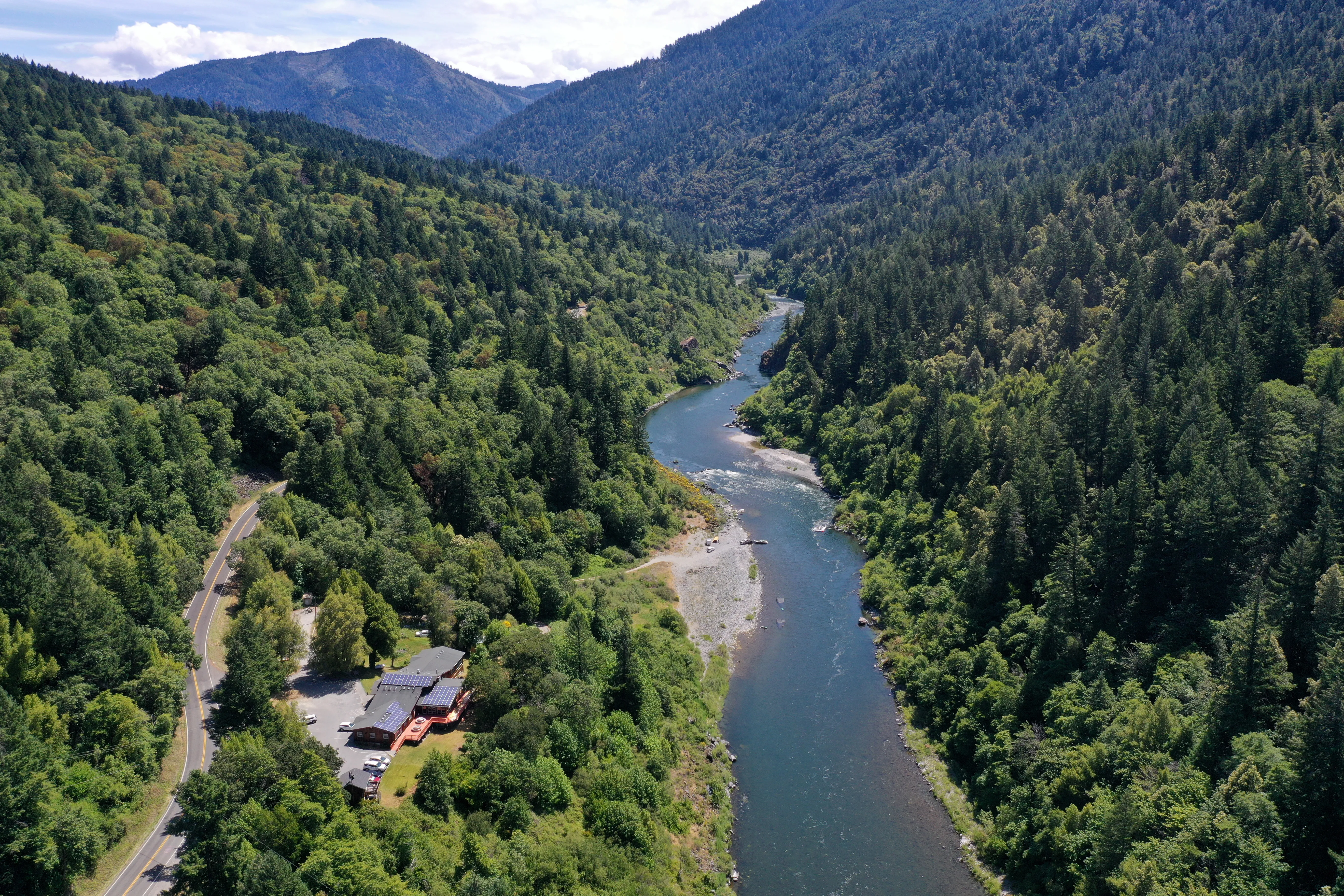 Aerial view of a river with lush greenery on both sides Aerial view of a river with lush greenery on both sides