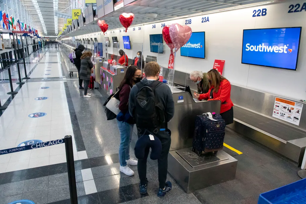 Passengers check in at the Southwest Airlines desk at Chicago O'Hare International on it's inaugural day on Feb. 14, 2021.