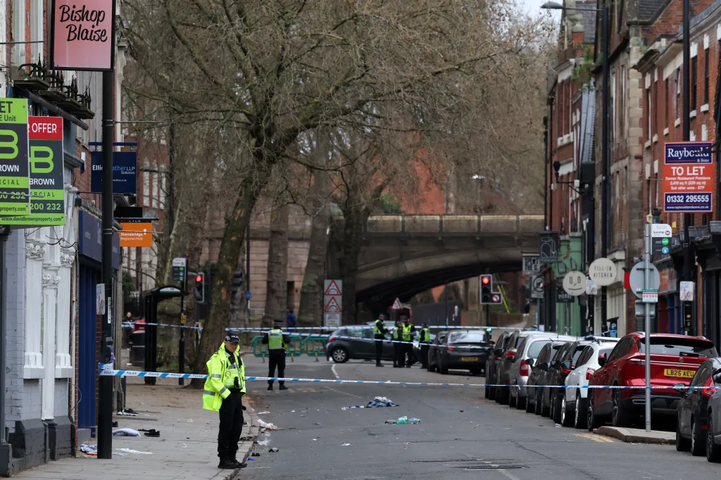 Police officers work near a cordon set up on Friar Gate in central Derby, central England on March 29, 2026, following an incident the night before where a driver crashed into pedestrians.