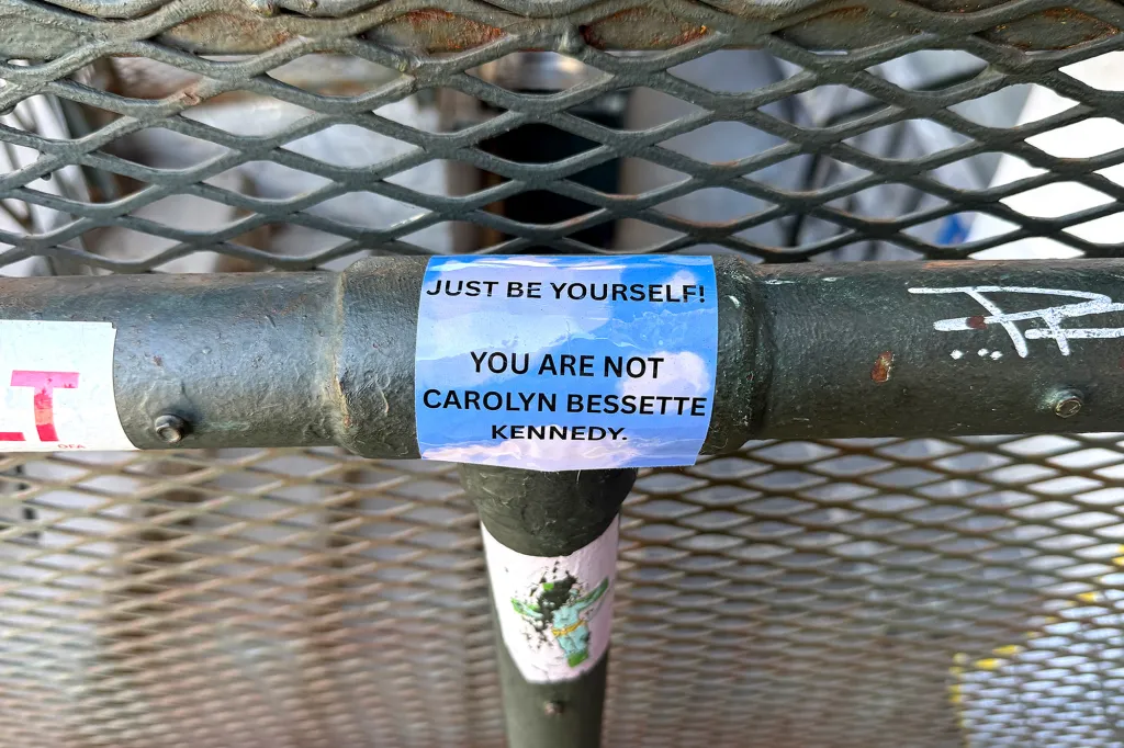 A light blue sticker on a metal bar reads, 