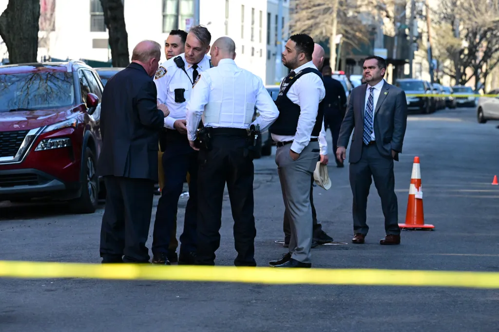 Police and investigators at 2103 Honeywell Avenue, where two men were shot.