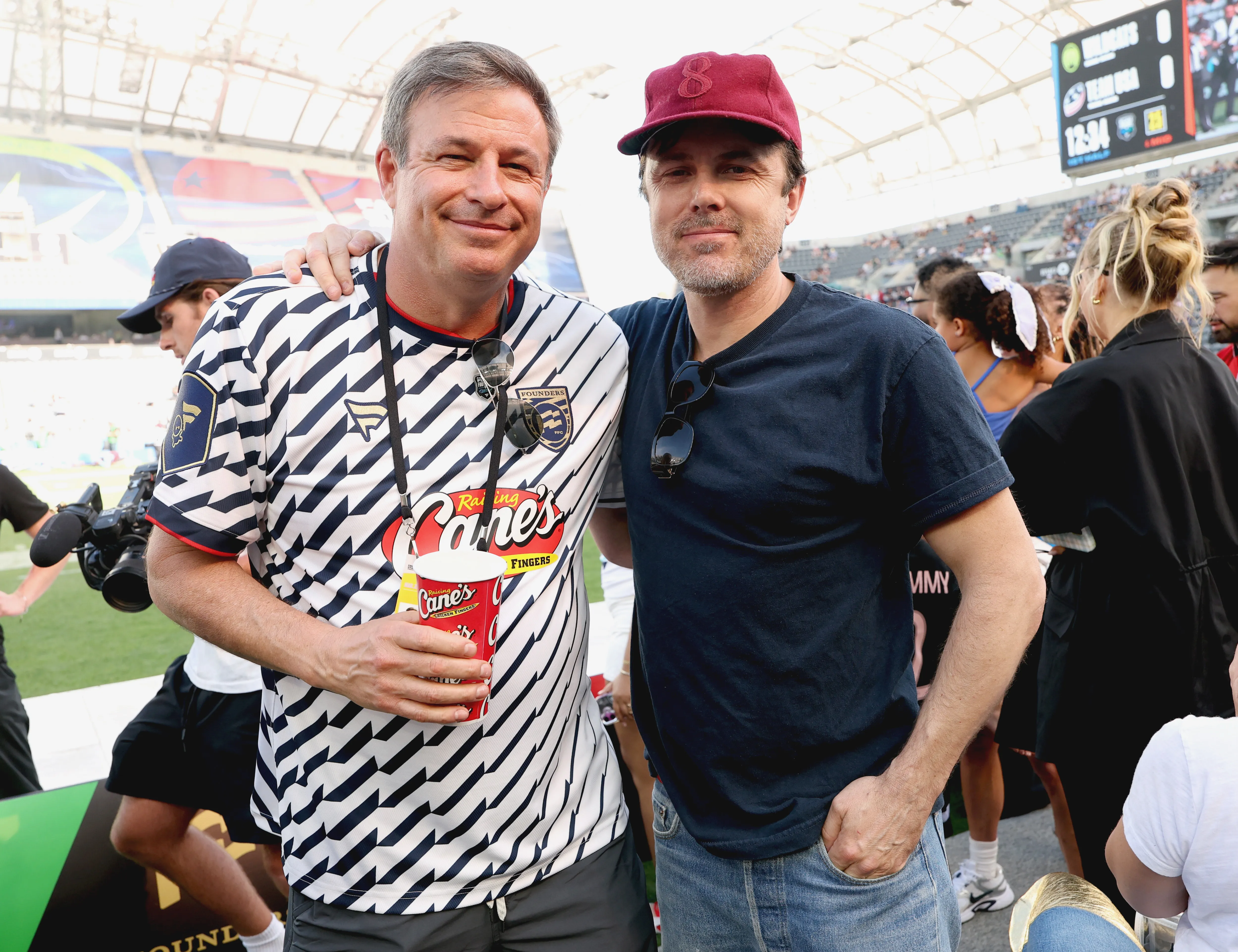 Two men pose for a photo at the Fanatics Flag Football Classic event.
