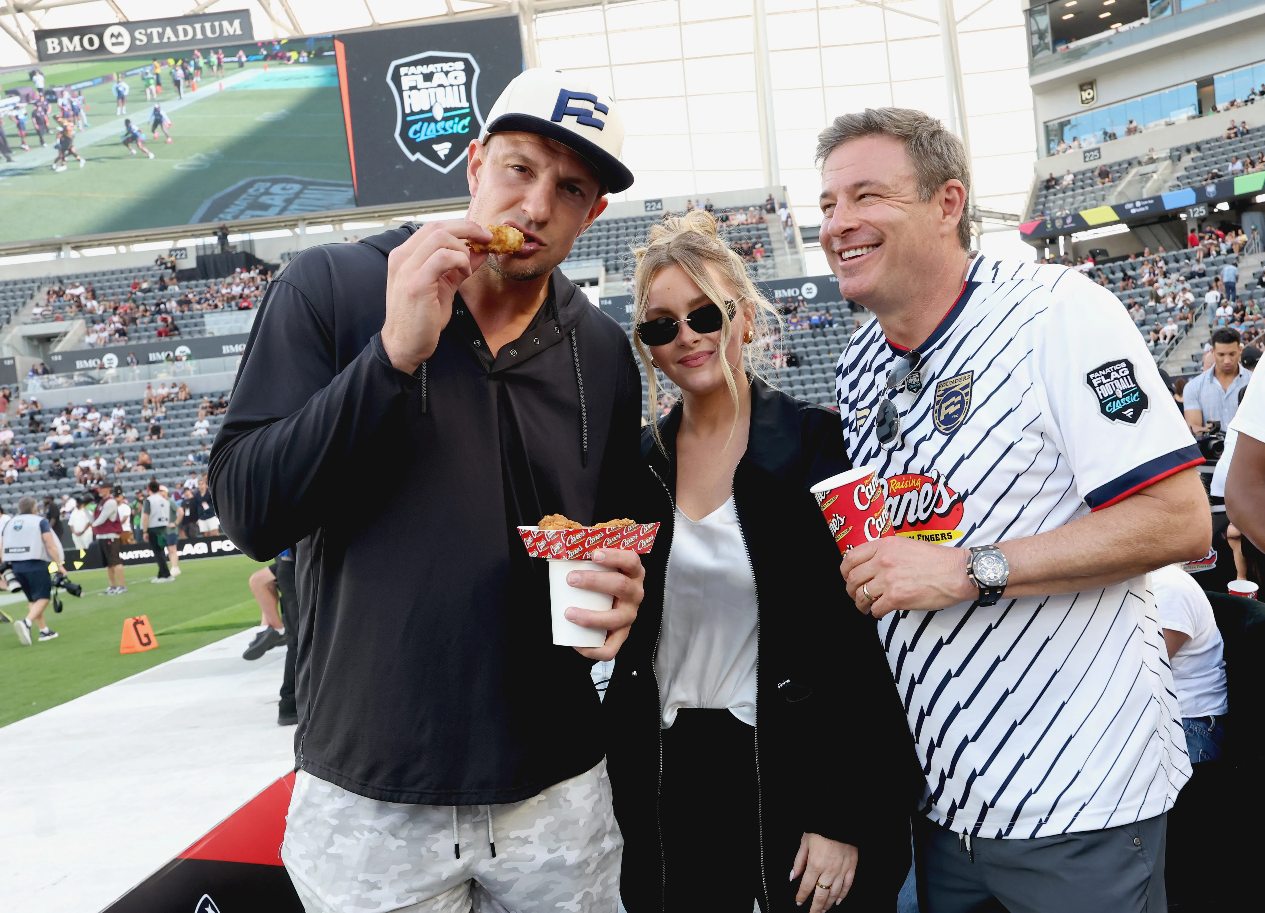 Rob Gronkowski, Camille Kostek, and an unidentified man are seen at the Fanatics Flag Football Classic.