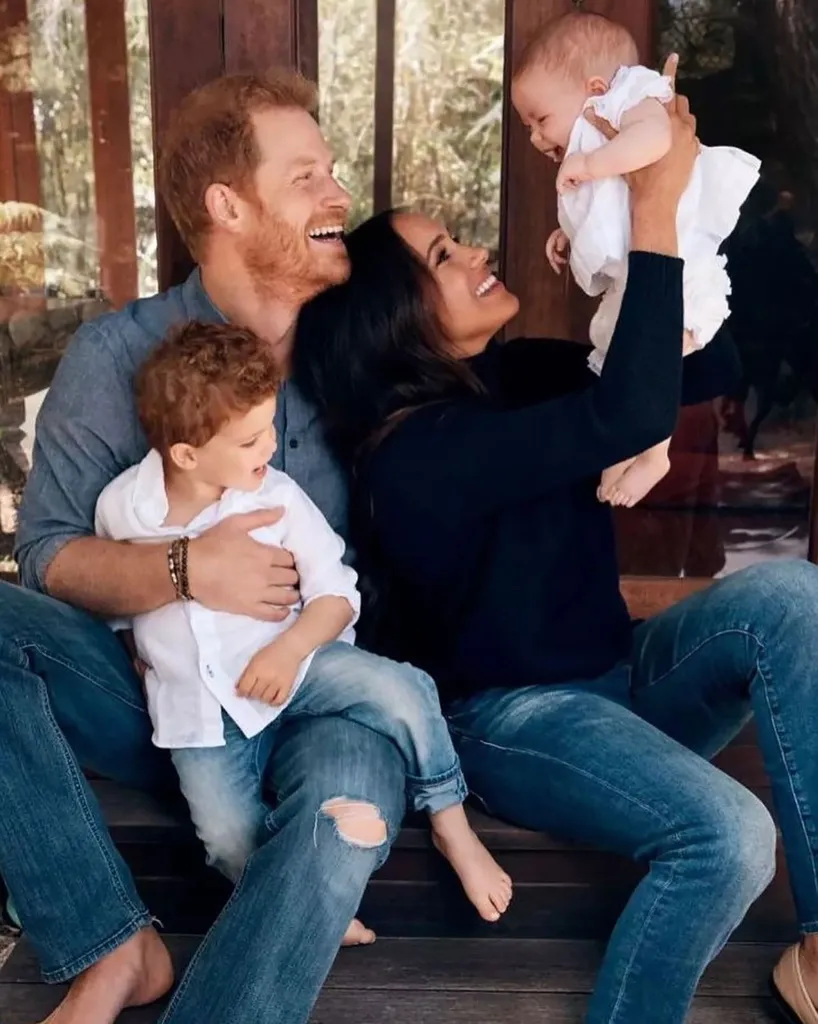 Meghan Markle, Prince Harry, and their two children laughing together.