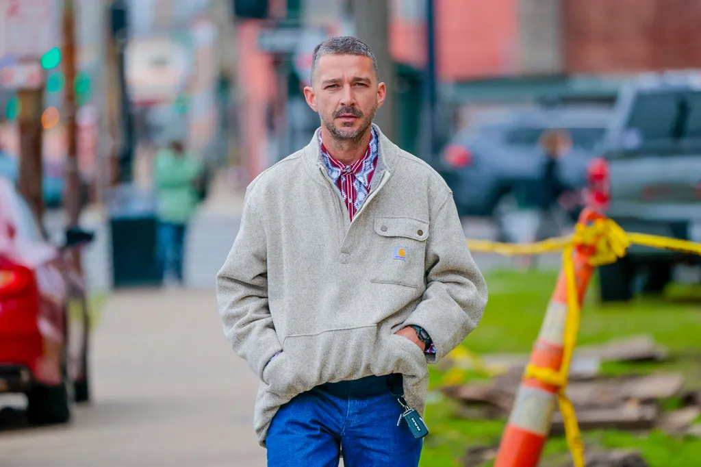 Shia LaBeouf, in a cream sweater, blue jeans and blue and red shirt, entering New Orleans Criminal Court.