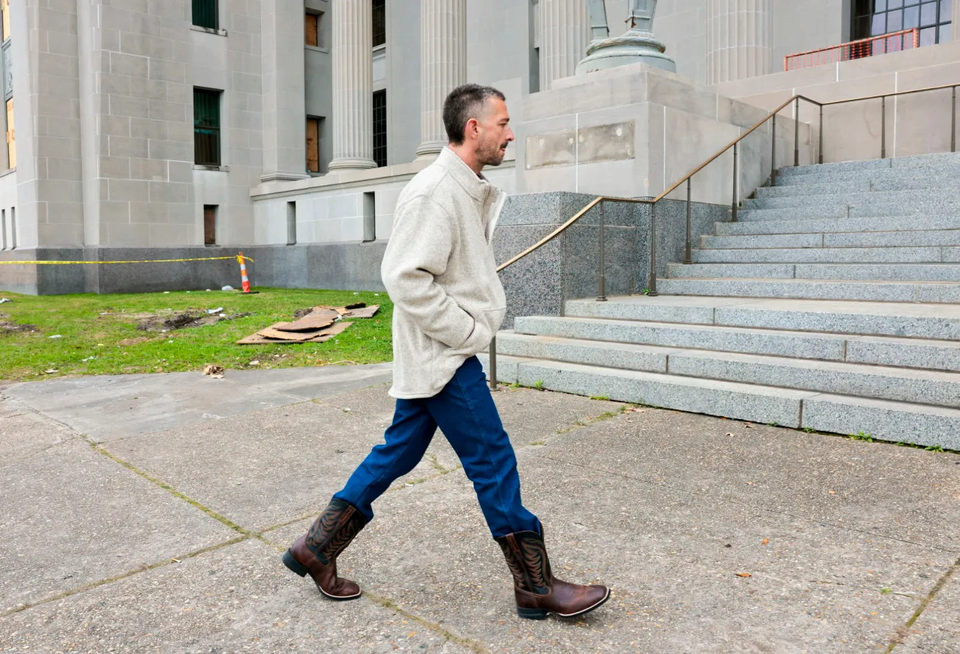 Shia LaBeouf walking outside a courthouse.