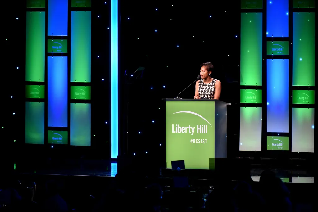 Amelia Williamson speaking at a podium with the 