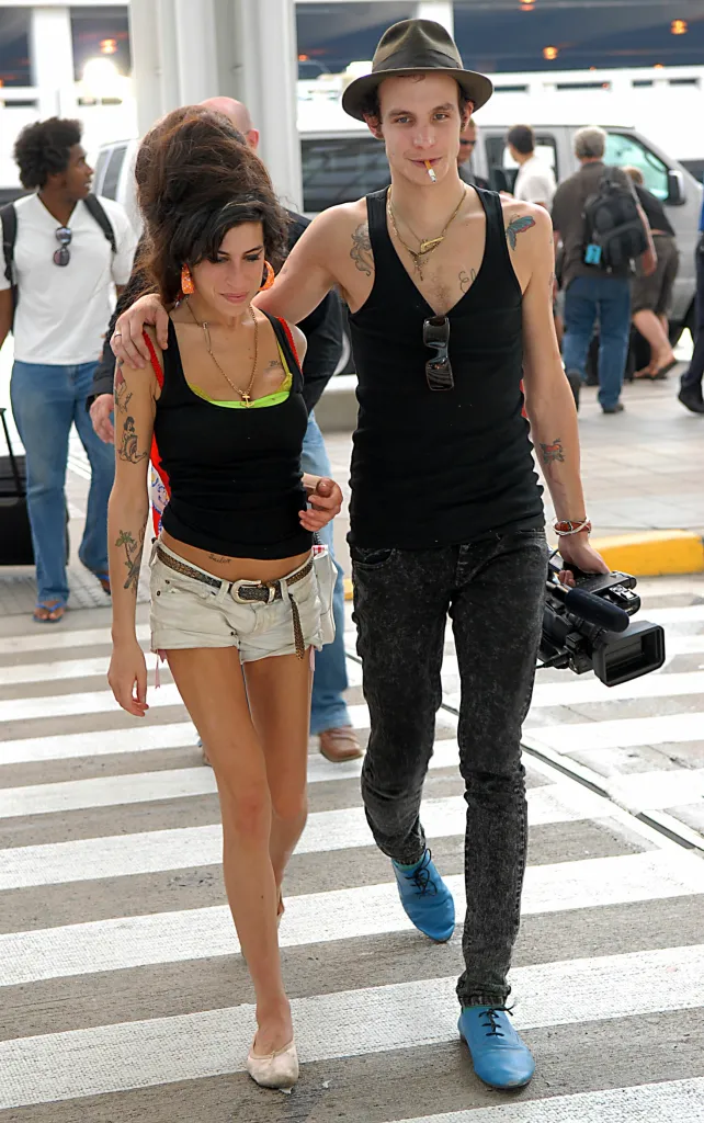 Amy Winehouse and Blake Fielder-Civil walking with a video camera.
