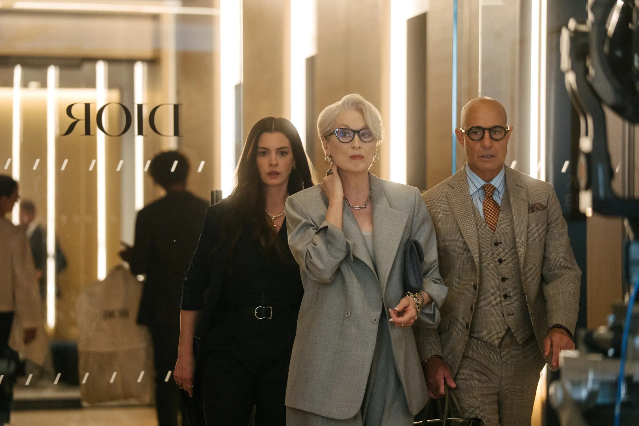 Anne Hathaway as Andy Sachs, Meryl Streep as Miranda Priestly, and Stanley Tucci as Nigel Kipling from 