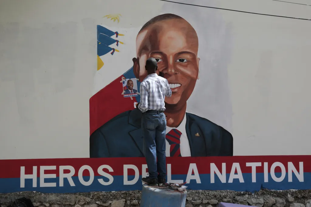 Artists paint a portrait of slain Haitian President Jovenel Moise near the presidencial residence where he was assassinated two years ago in the Petion-ville area of Port-au-Prince, Haiti, July 7, 2023. 