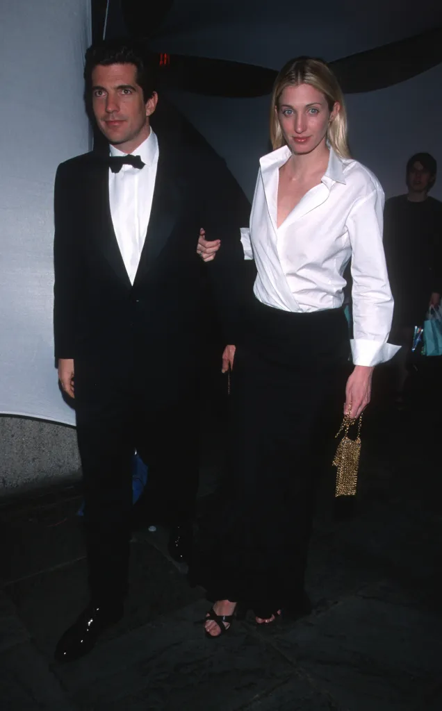 John F. Kennedy Jr. in a tuxedo and Carolyn Bessette-Kennedy in a white shirt and black skirt attend the Brite Night Whitney Fundraising Gala.