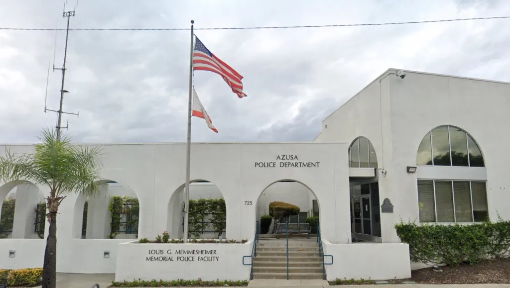 Azusa Police Department building with US and California flags flying.