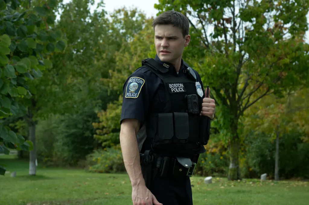 Mika Amonsen as Sean Reagan, a Boston police officer in uniform and tactical vest, looking to his right.