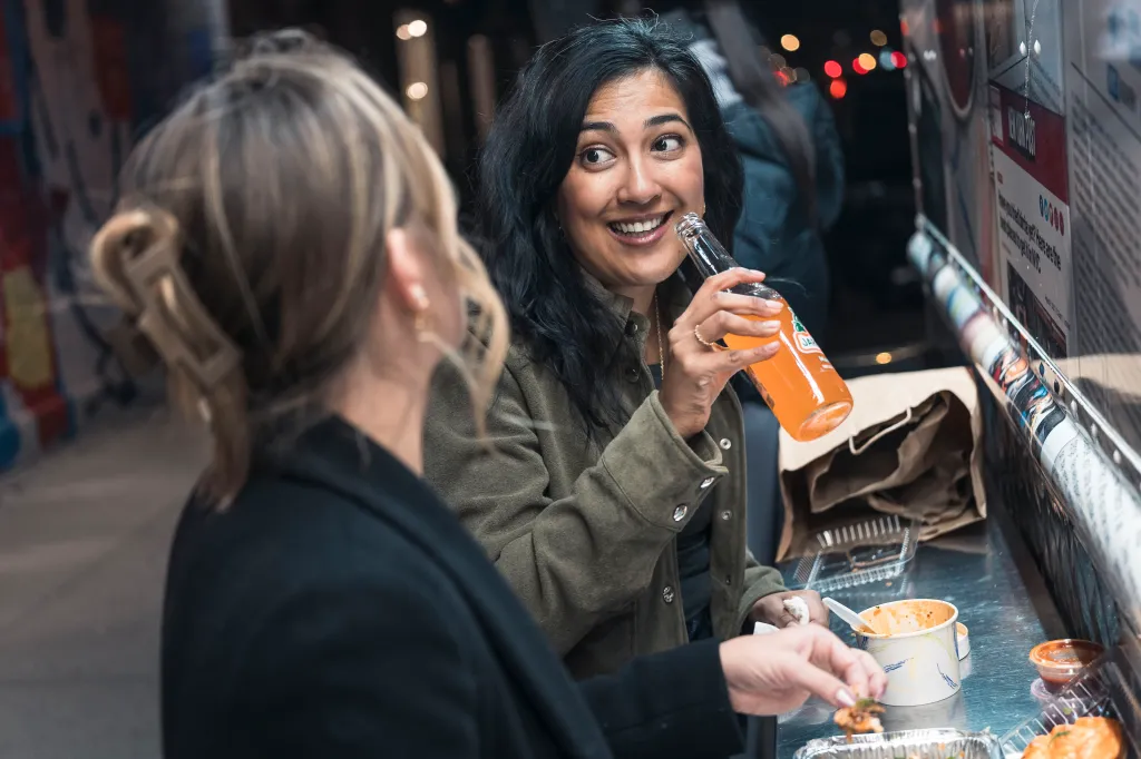 Veronica and Julie having tacos and drinks from a taco truck.