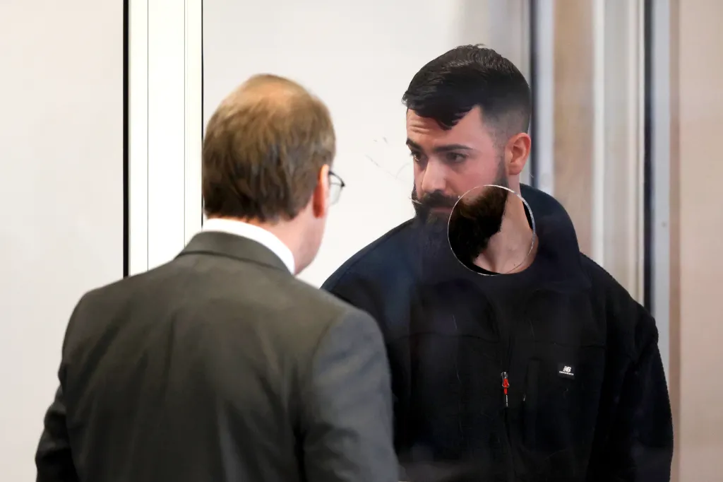 Boston Police Officer Nicholas O'Malley, right, speaks to his attorney during his arraignment in Roxbury Municipal Court in Boston on Thursday, March 19, 2026, for manslaughter charges in the fatal shooting of Stephenson King. 